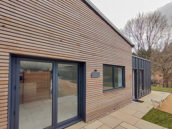 barn conversion with timber clad and zinc clad walls