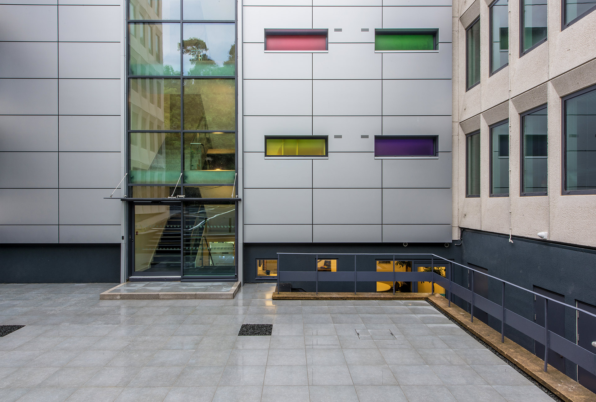 courtyard area outside office block with coloured windows