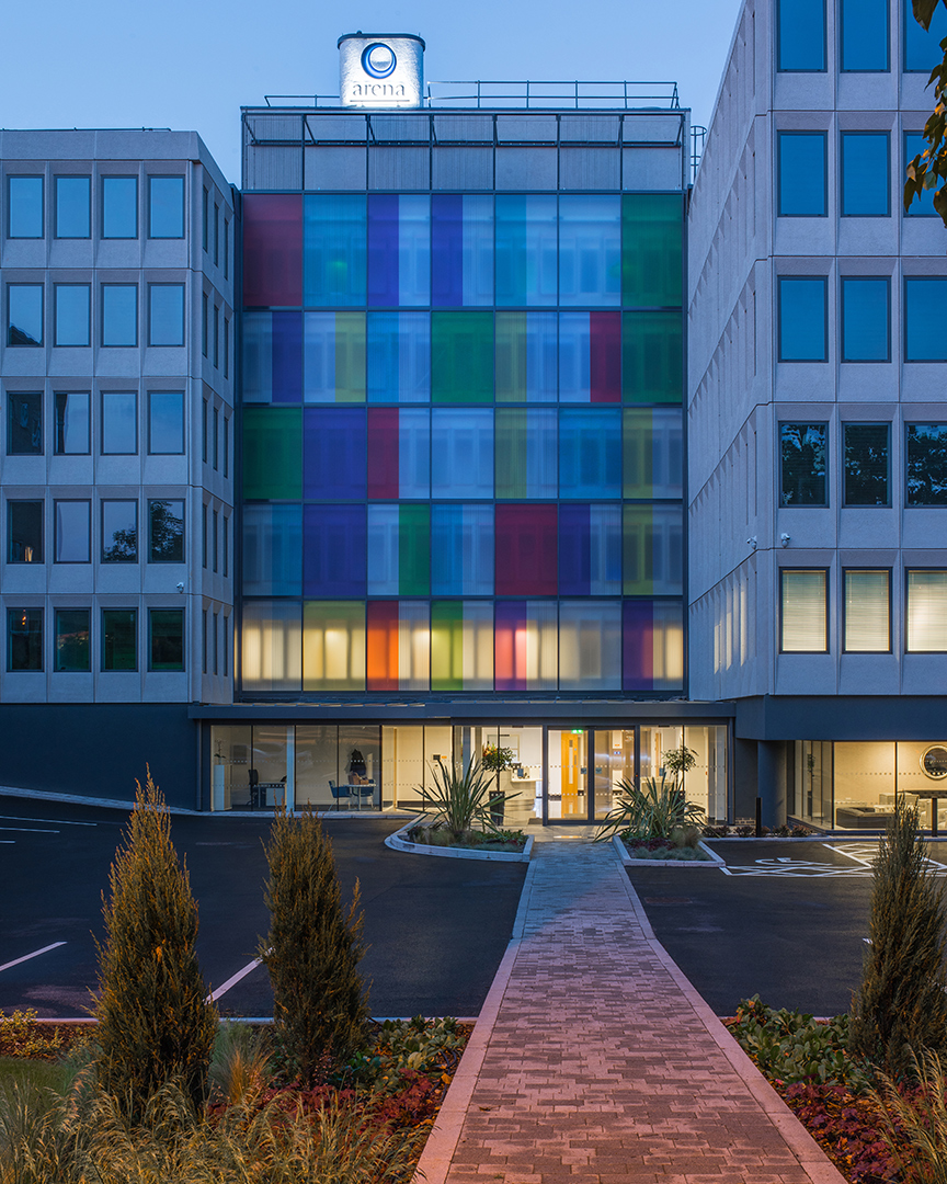 entrance to reception area of office building including path from car park to reception taken at dusk with lights on