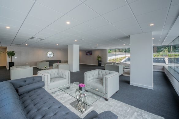 interior breakout space in grey tones with sofas and tables