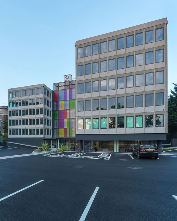 front view and entrance of large commercial building with feature colourful windows in middle section