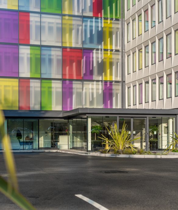 detail entrance exterior with glass windows and colourful windows from first floor