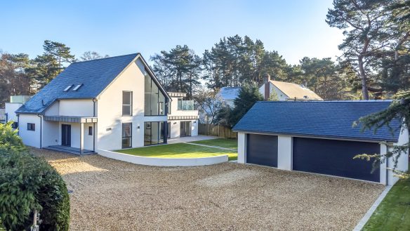 exterior aerial proto of modern white house and detached garage