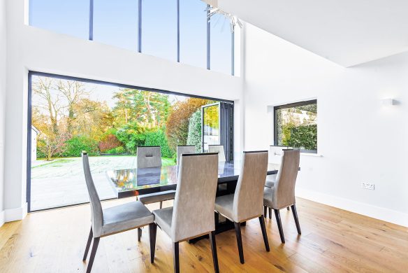 interior modern dining area with double height and sliding glass doors