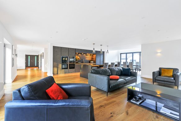 open plan living and kitchen area with wooden floor