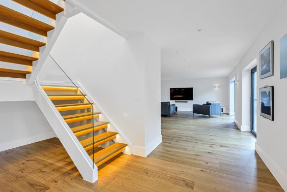 interior dog legged staircase with lights under each floating step