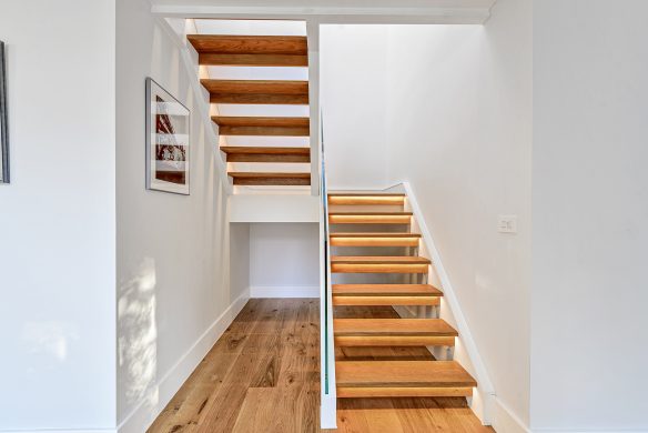 dog legged wooden floating staircase with lights