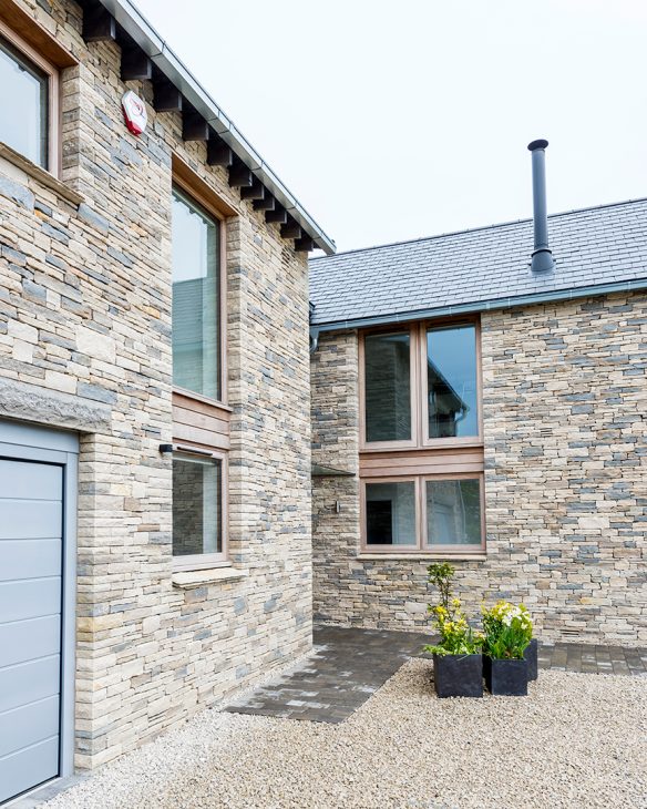 side entrance view of house with stone walls