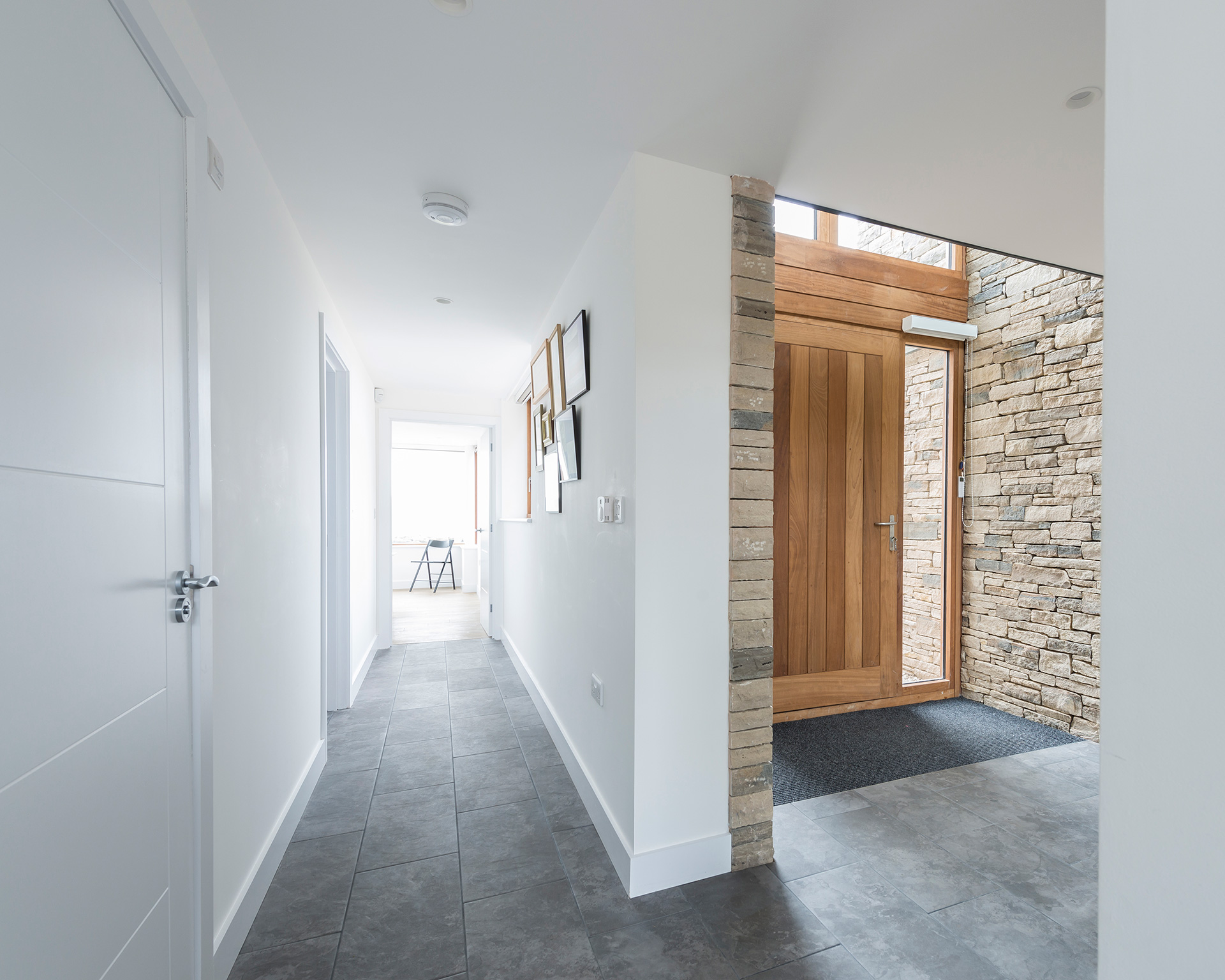 interior modern entrance and corridor with feature stone wall