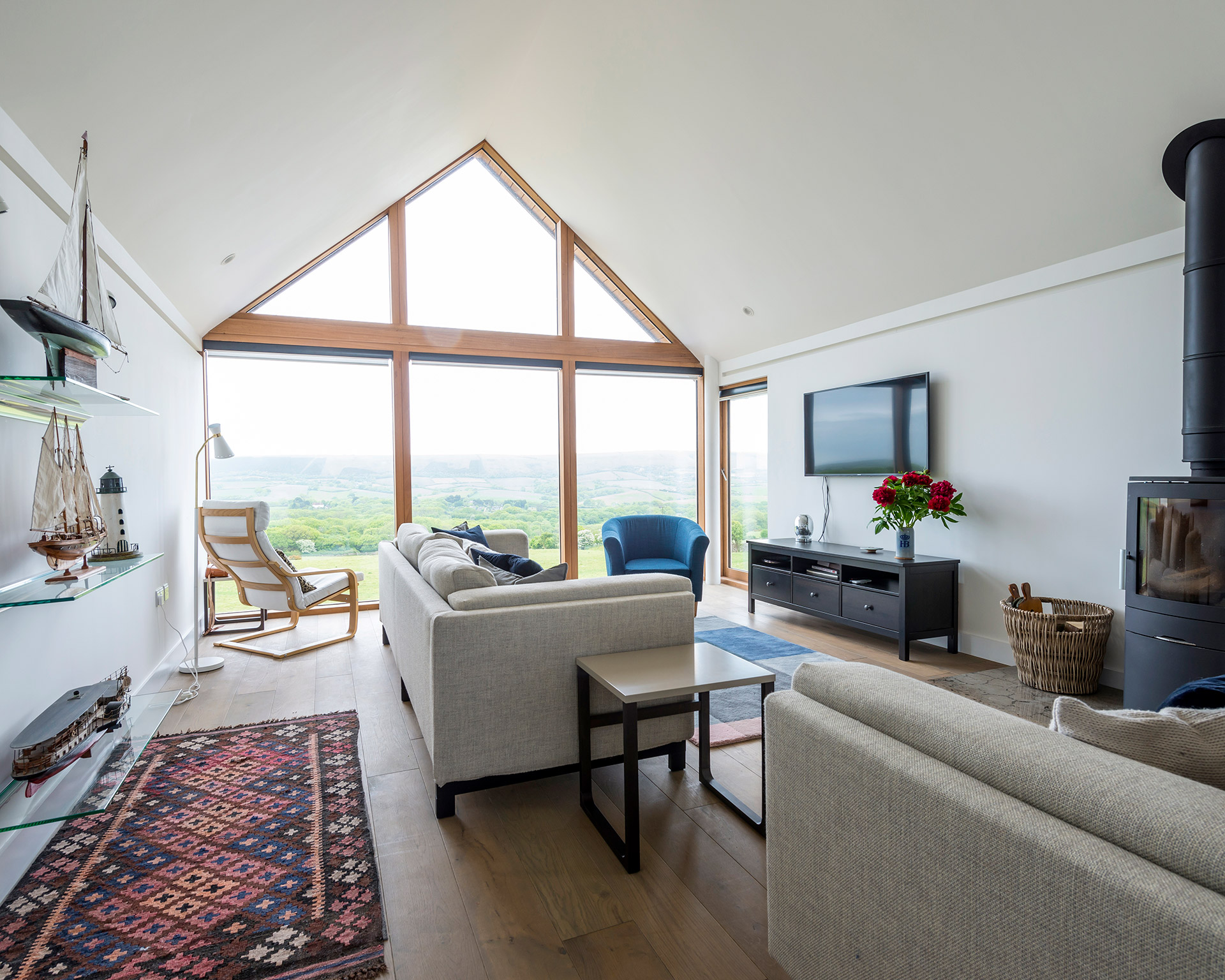 living room with apex roof and large windows with stunning countryside views