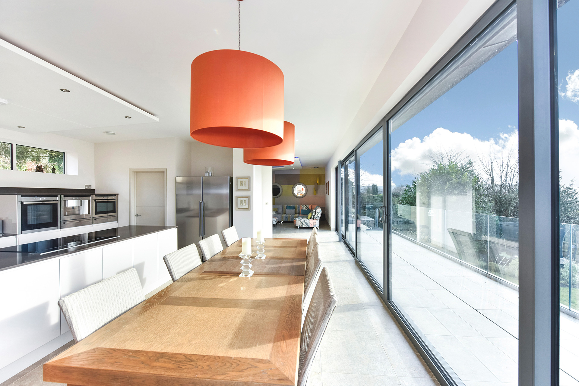 open plan kitchen dining area with sliding doors leading to balcony