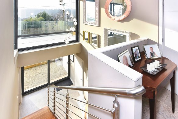 double height hallway with staircase and large windows