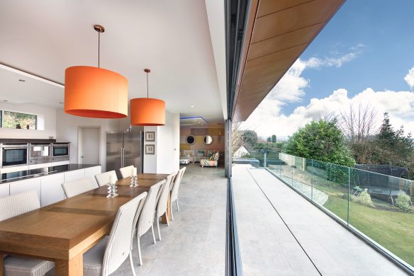 balcony view of house and garden with large sliding doors