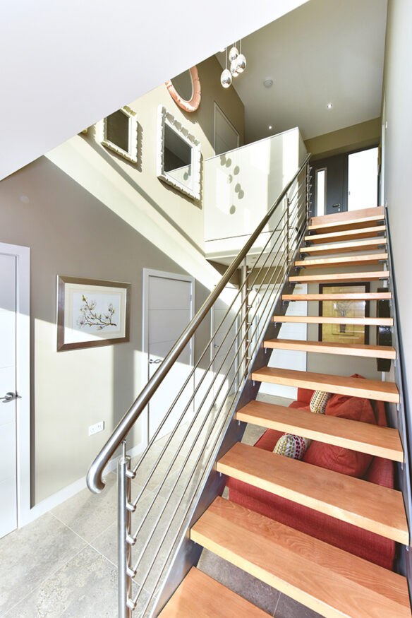 wooden floating staircase with metal balustrade