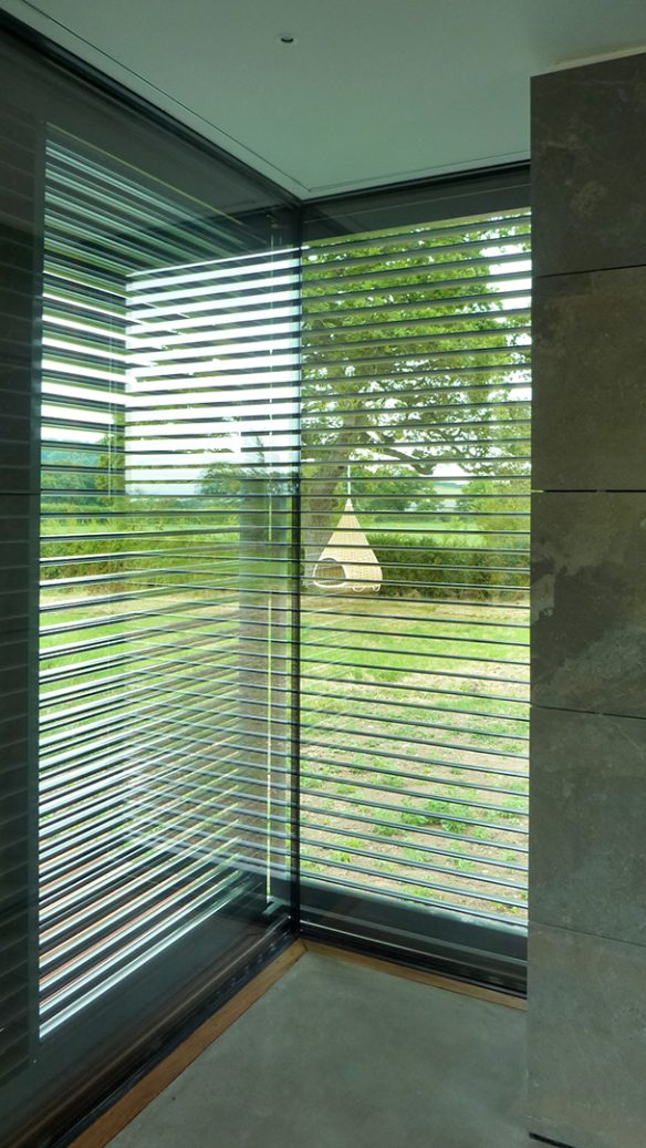 corner glazing detail with beautiful garden and countryside views