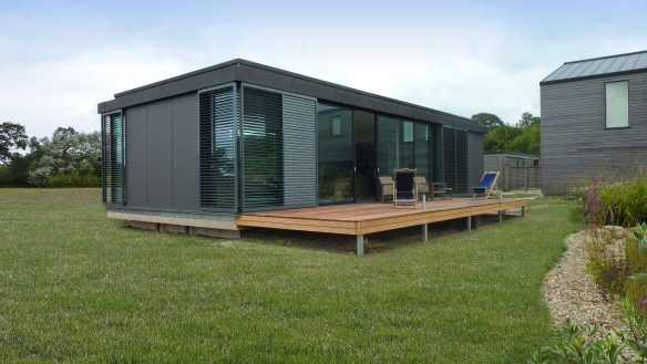 decking area outside single storey house with zinc cladding