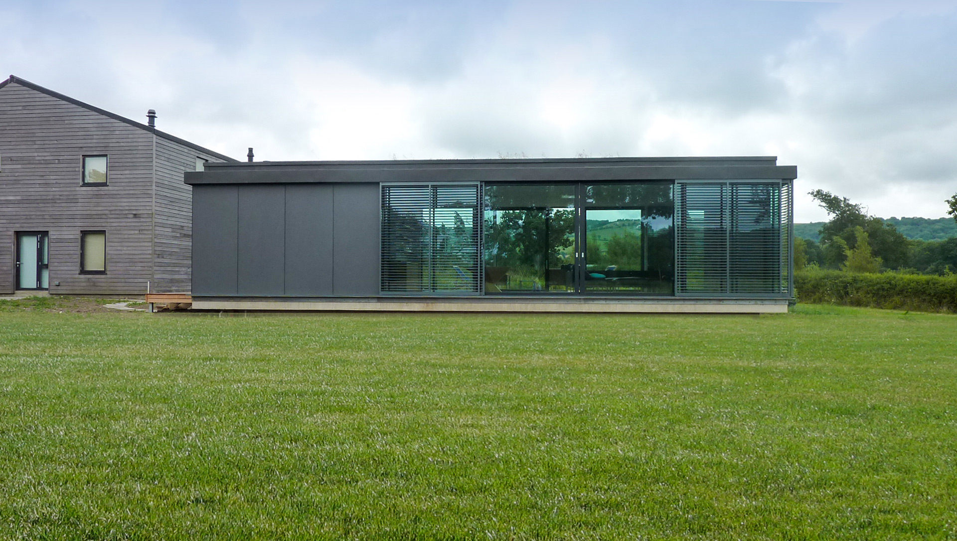 rear view of house with zinc cladding and large windows