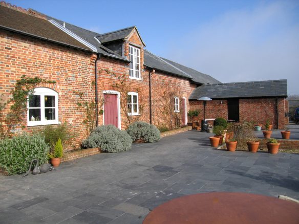red brick cottage with courtyard area outside