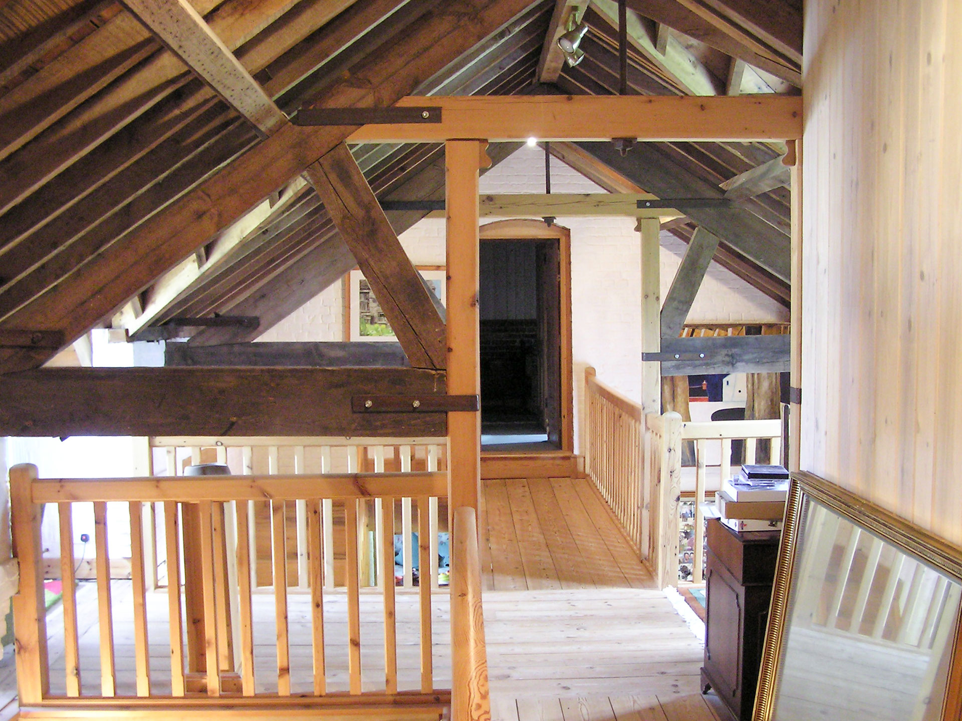 first floor hallway with exposed wooden beams