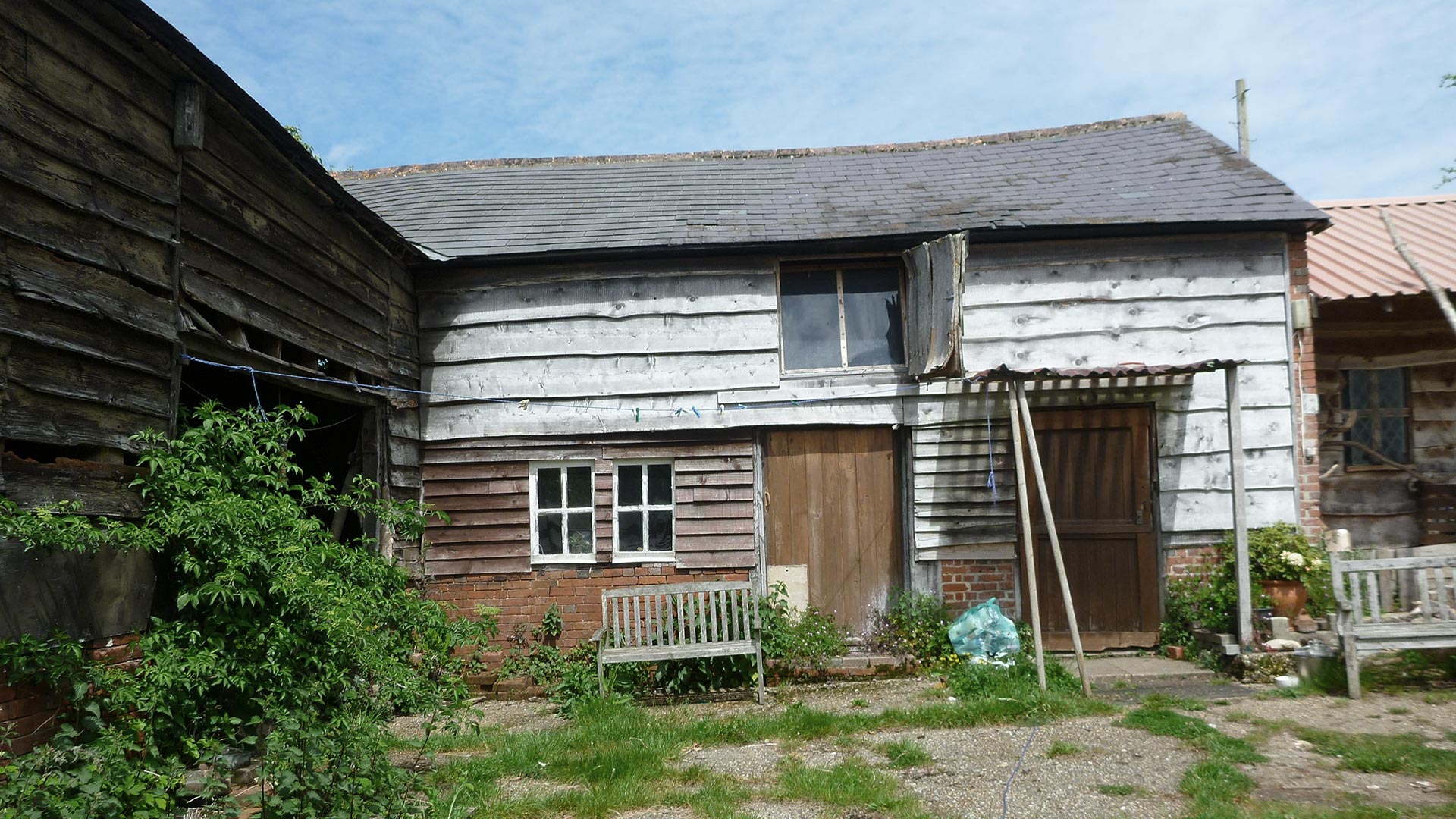 existing barn with wood cladding and tiled roof