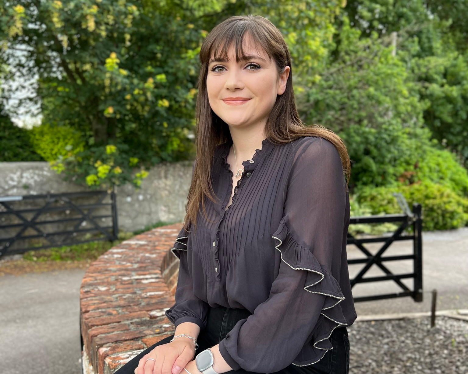 rebecca holden sitting on wall