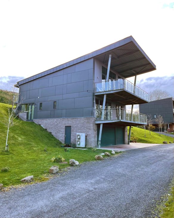 side view of modern house with overlapping balconies and sloping roof