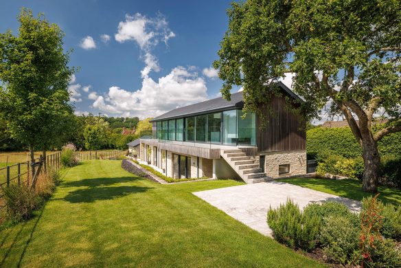 approach view of contemporary house with garden and trees