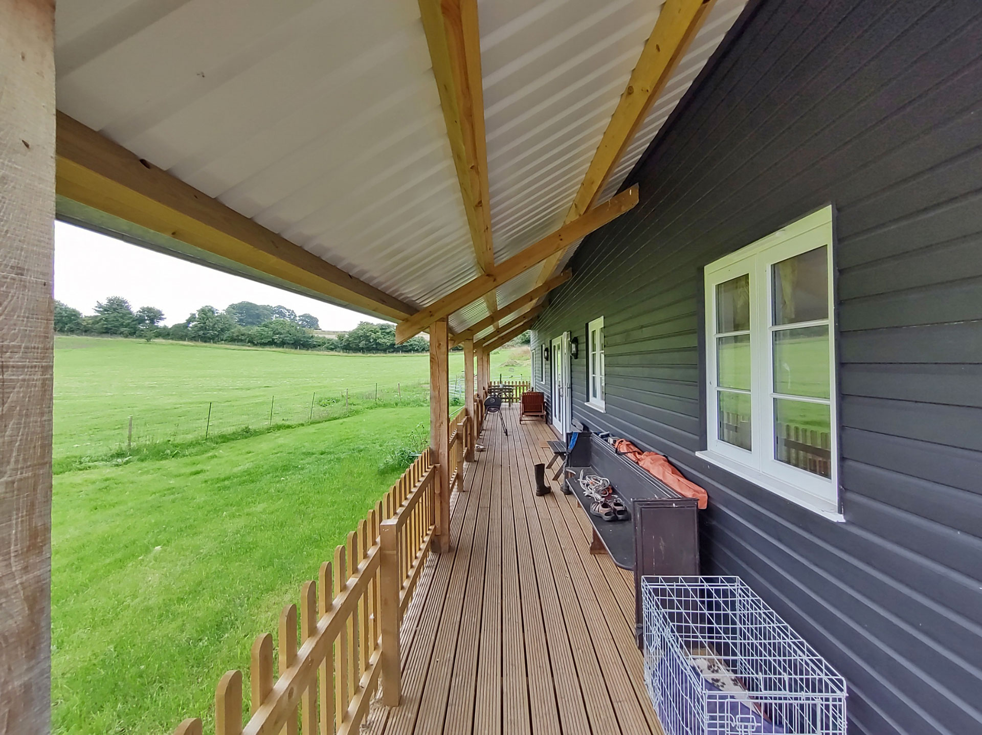 long veranda outside barn conversion painted black