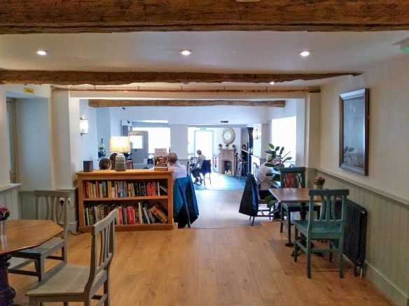 open plan dining area inside pub with seating areas