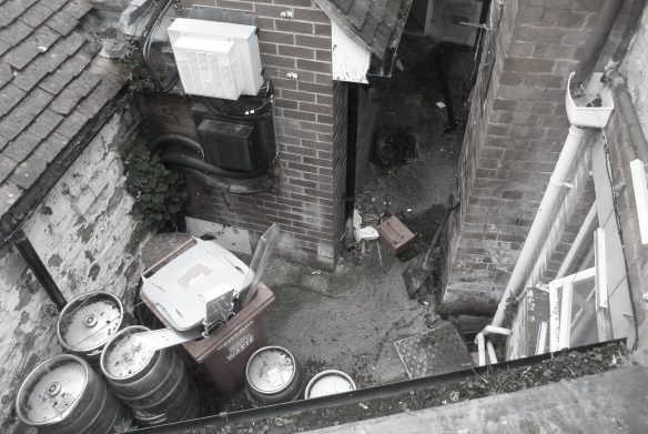 before photo of enclosed courtyard area behind pub