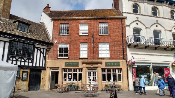 street view of pub with red brick walls and seating area outside