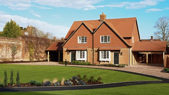 new pair of houses with car ports on each side and garden lawn in front