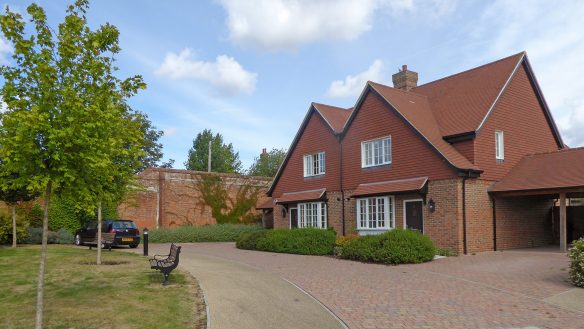 semi-detatched houses with red brick walls and tiled private driveway