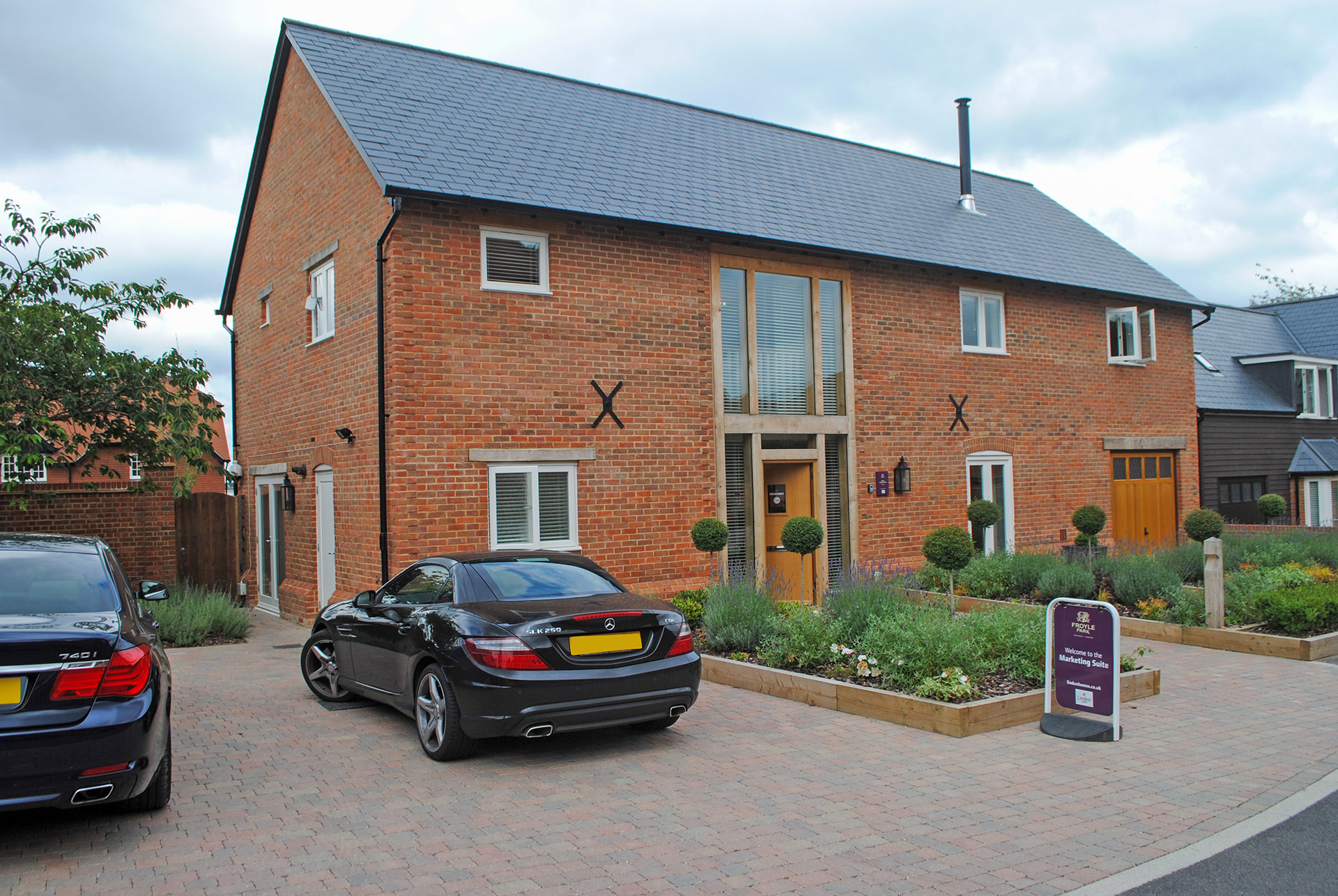 red brick houses with private driveway and flowerbeds