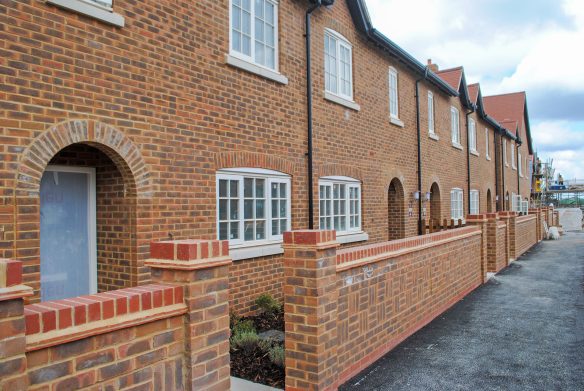 street scene of red brick houses under construction