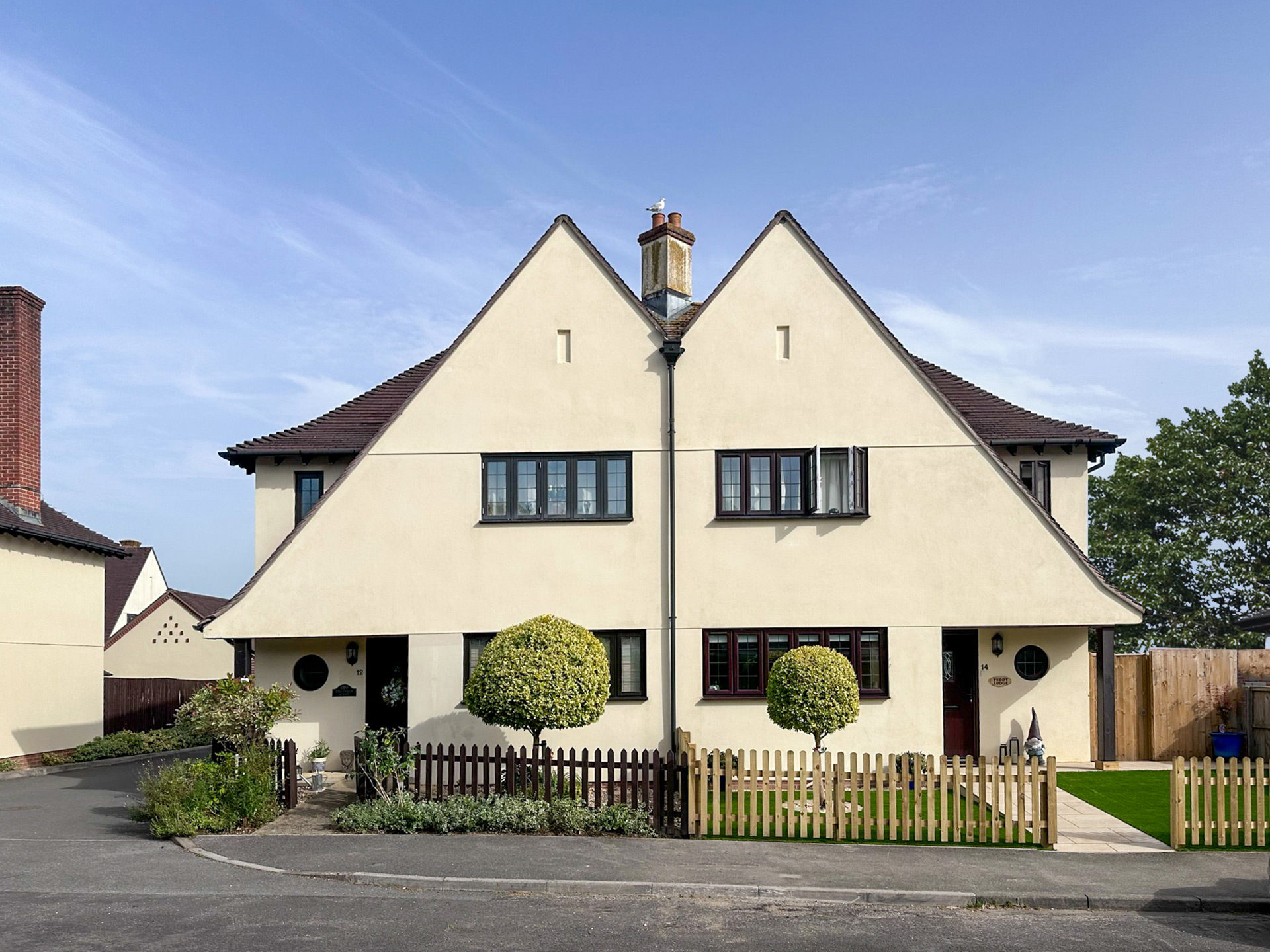 front view of pair of houses with mirrored design and sloping roof