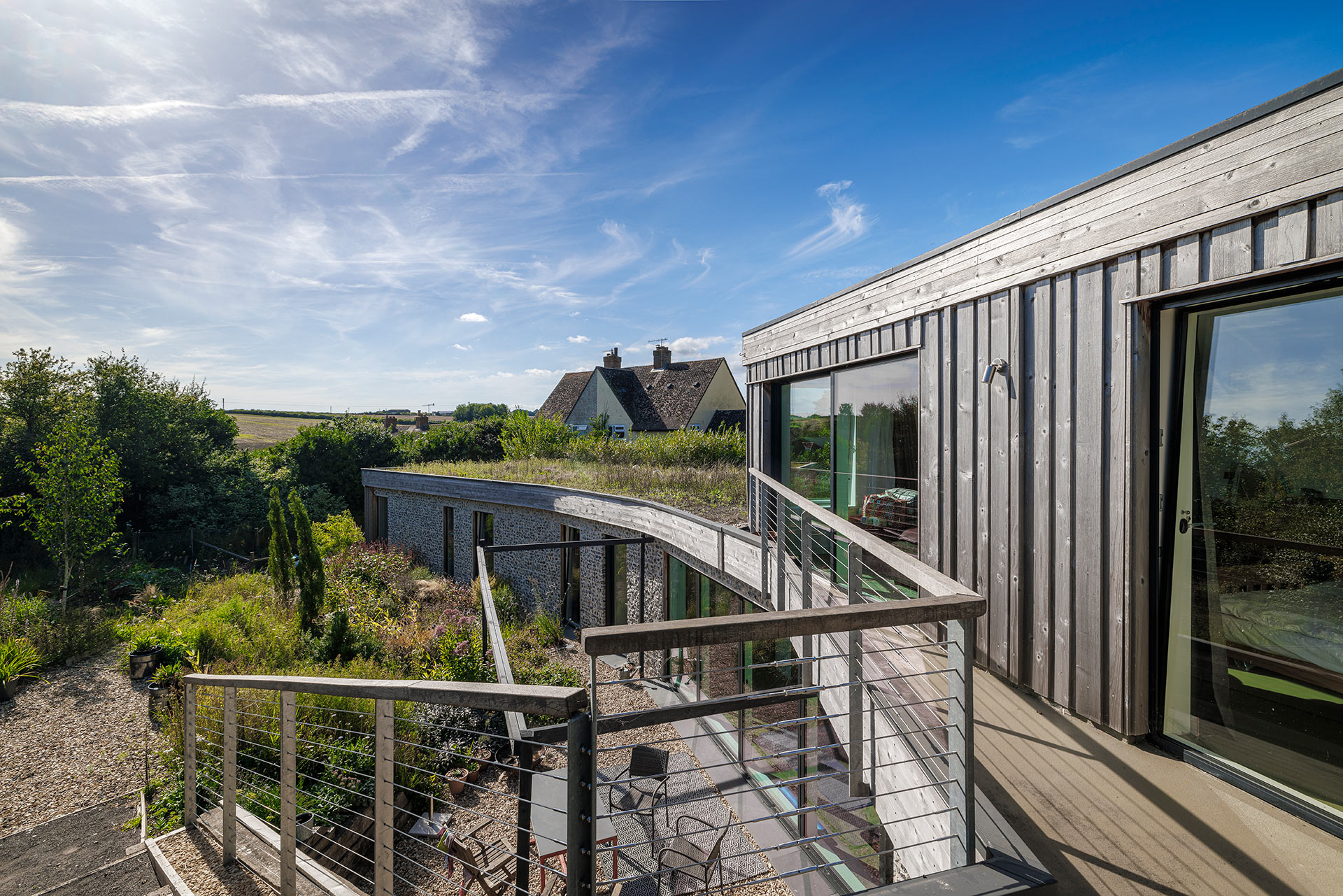 wooded clad house with hidden ground floor and sedum green roof