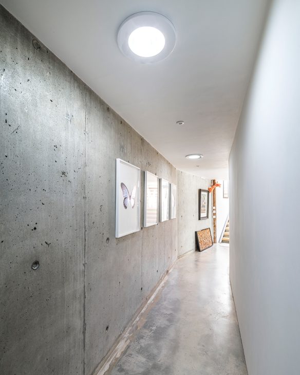 internal corridor in house with modern concrete walls and spotlights