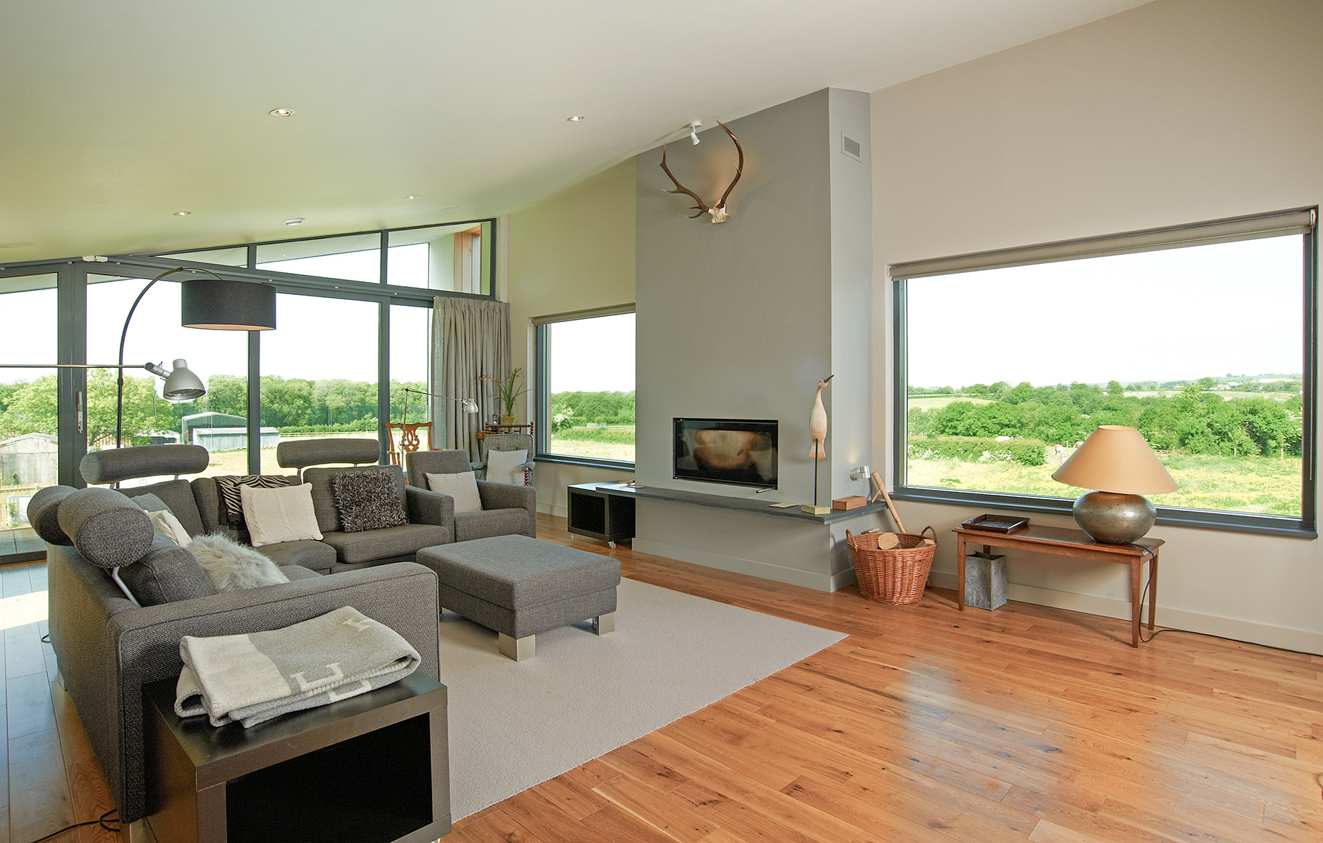 Interior open plan modern living area with large windows with beautiful countryside views