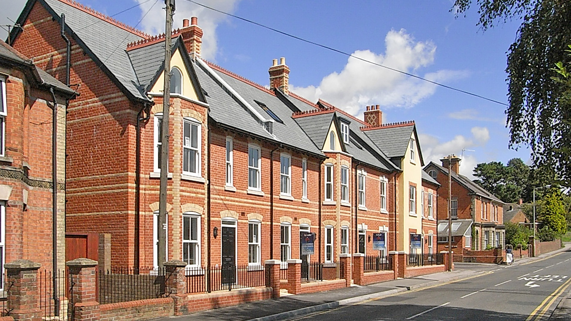 road view of attractive town houses in red brick