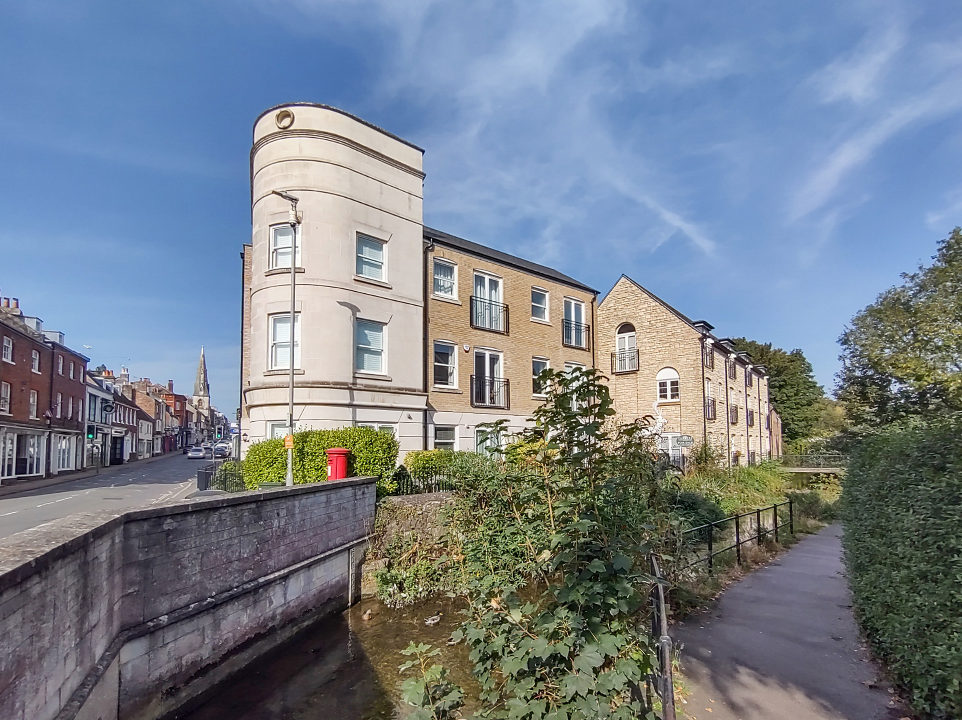 converted flats with featured curved wall taken from across river