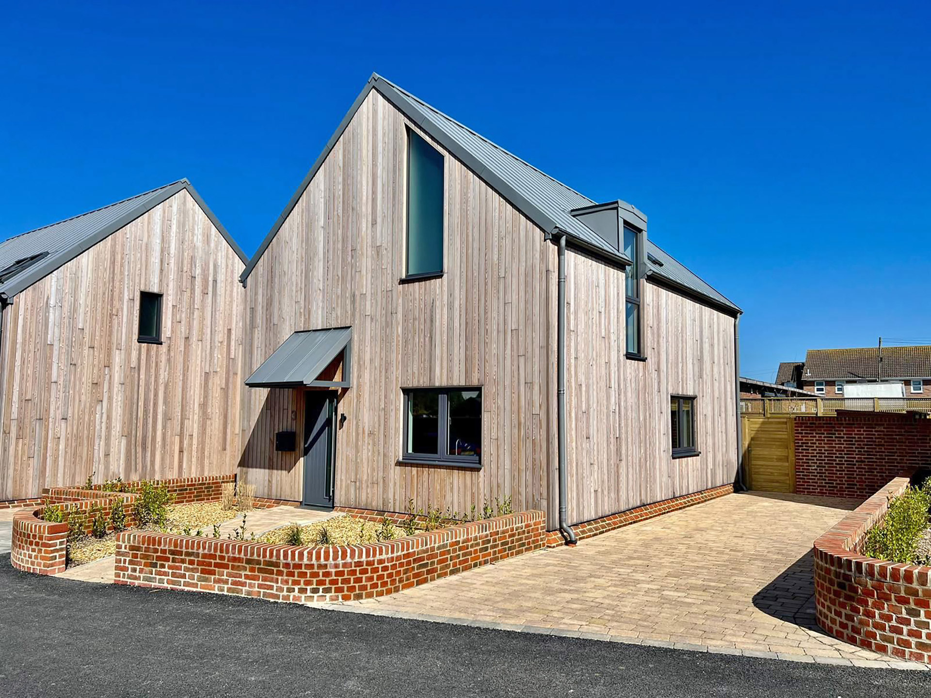 approach view of contemporary house with timber cladding