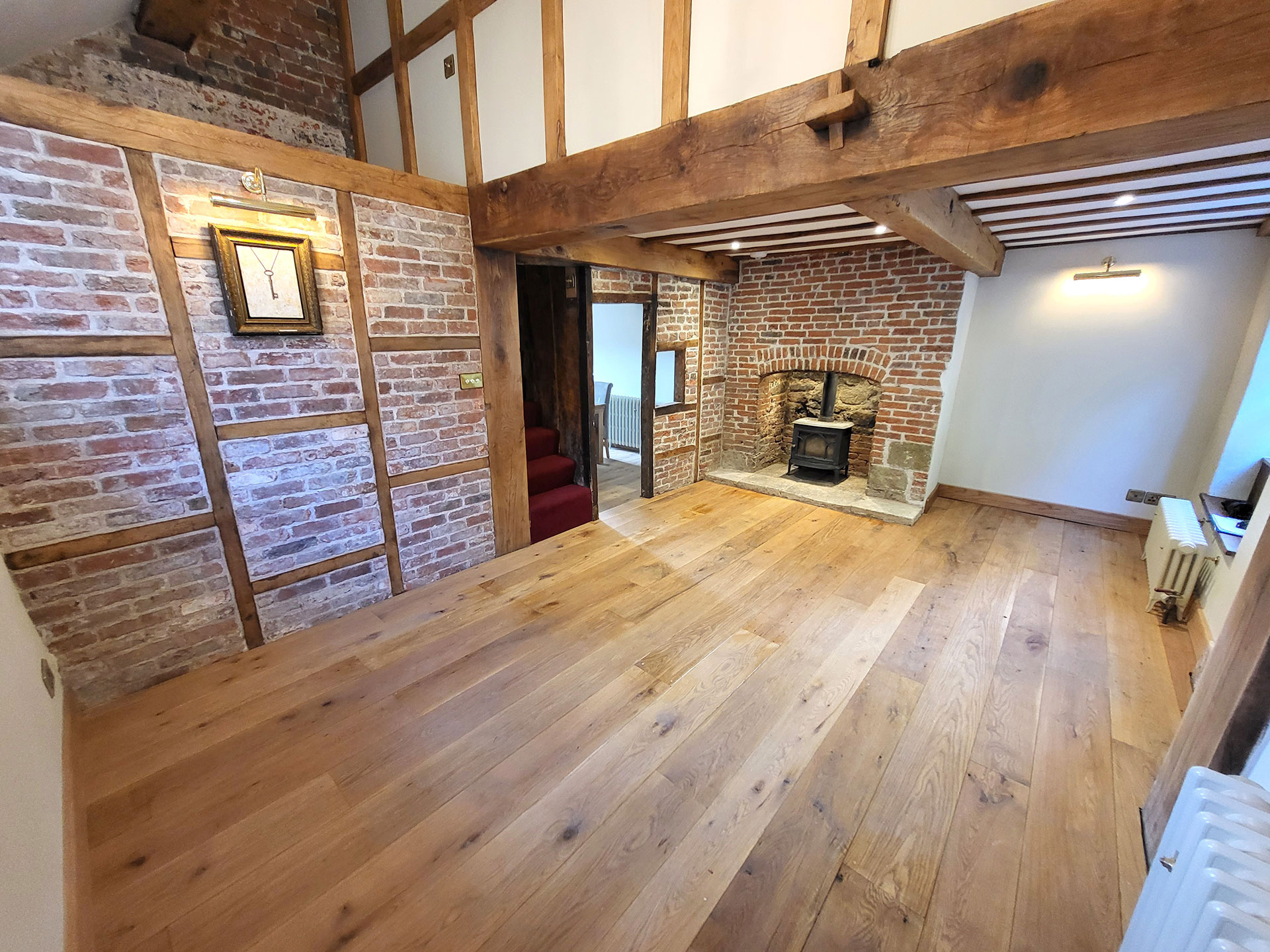 cosy living area with wood floors and log burner in fireplace