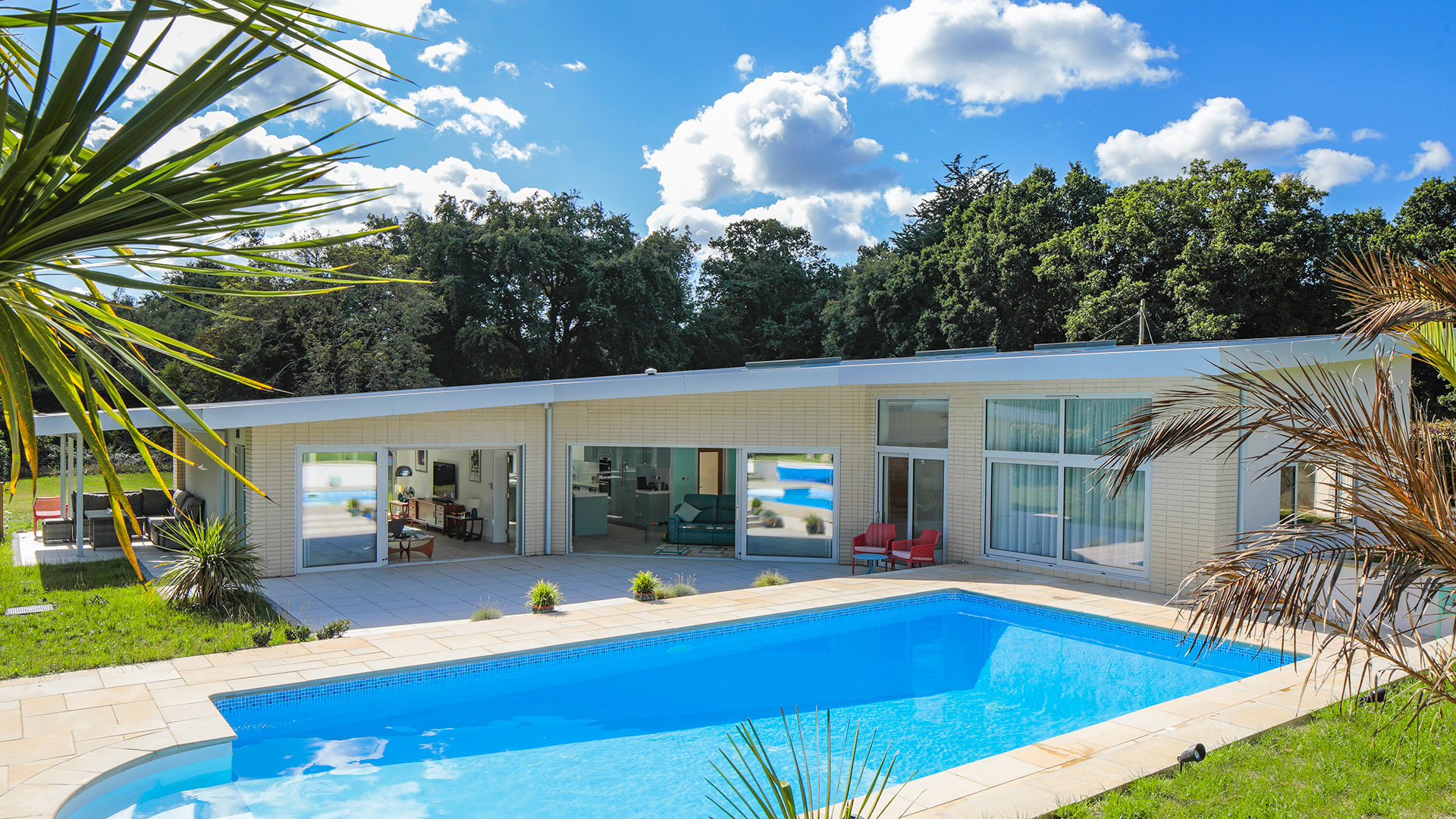 Californian style house with large outdoor pool in sunshine