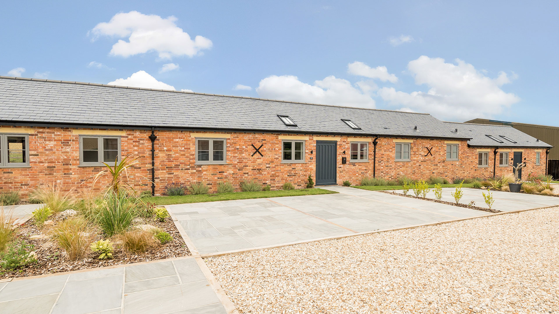 converted barns into housing with red brick