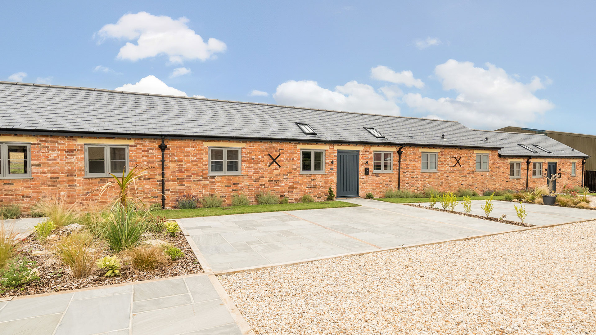 converted barns into housing with red brick