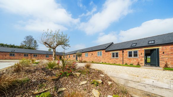 converted barns into housing with red brick