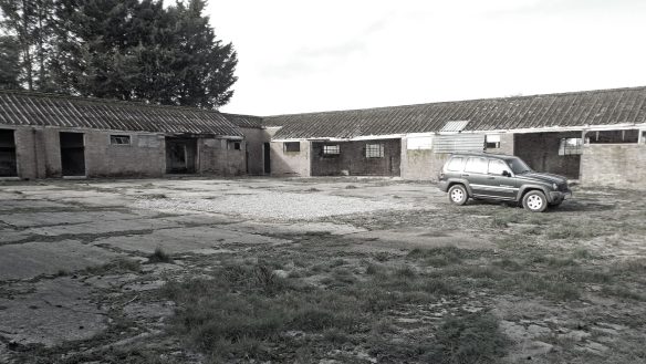before photo of barns surrounding courtyard