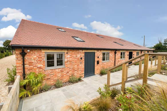beautiful barn conversion with patio area in front