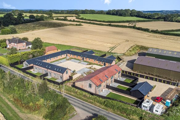 aerial view of converted farm courtyard and outbuildings surrounded by countryside